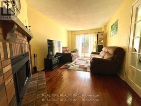 Oakville (Ga Glen Abbey) townhouse for rent - A living room with a fireplace and a couch.