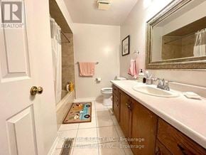 Oakville (Ga Glen Abbey) townhouse for rent - A bathroom with a sink, mirror, toilet, and a rug on the floor.