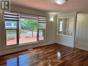 Welland (Lincoln/Crowland) house for rent - A room with wooden floors and a view of a deck through the windows.