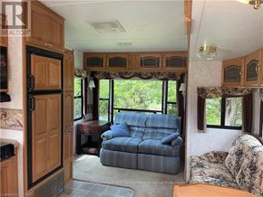 Northern Bruce Peninsula mobile home for rent - A living room with a couch and a window.