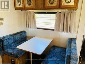 Northern Bruce Peninsula mobile home for rent - A small table and two couches are in a living room.