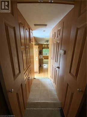 Northern Bruce Peninsula mobile home for rent - A hallway with wooden doors and a tiled floor.
