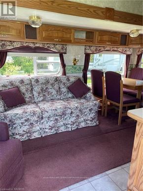 Northern Bruce Peninsula mobile home for rent - A living room with a couch and chairs.