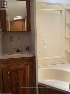 Northern Bruce Peninsula mobile home for rent - A bathroom with a sink and a bathtub.