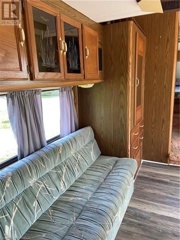 Northern Bruce Peninsula mobile home for rent - A living room with a couch and wooden cabinets.