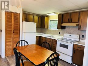 Northern Bruce Peninsula mobile home for rent - A kitchen with a table and chairs.
