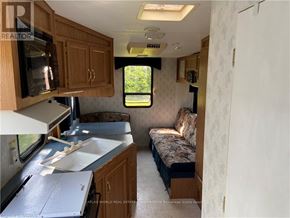 Northern Bruce Peninsula mobile home for rent - A kitchen area with a sink and microwave.