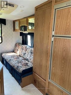 Northern Bruce Peninsula mobile home for rent - A wooden cabinet with a glass door is in the image.