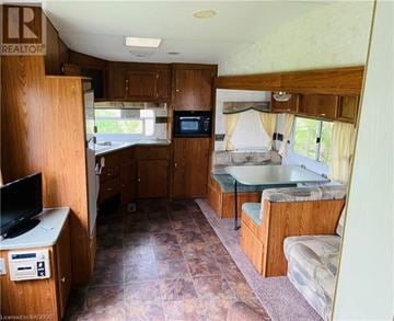 Northern Bruce Peninsula mobile home for rent - A living area with a couch and a television set.
