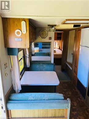 Northern Bruce Peninsula mobile home for rent - A small room with a bed and a table.