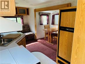 Northern Bruce Peninsula mobile home for rent - A small room with a table and chairs in it.