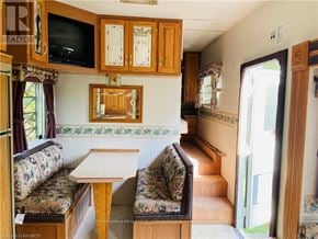 Northern Bruce Peninsula mobile home for rent - A living room with a couch, a table, and a television.