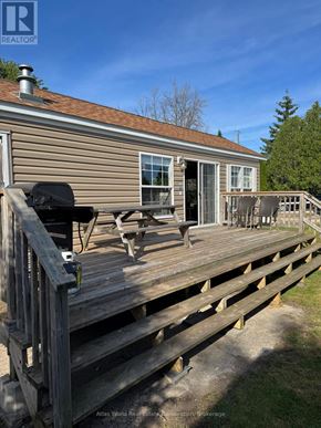 Northern Bruce Peninsula mobile home for rent - A house with a deck and patio furniture.