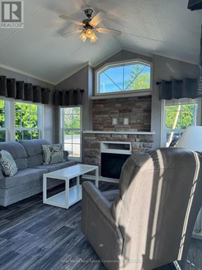 Northern Bruce Peninsula mobile home for rent - A living room with a grey couch, a white coffee table, and a beige armchair.