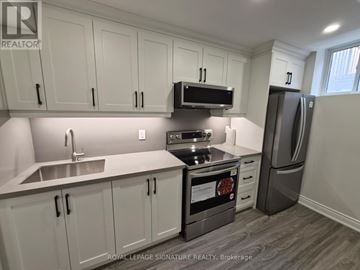 Brampton (Heart Lake East) townhouse for rent - A kitchen with white cabinets and a stainless steel refrigerator.