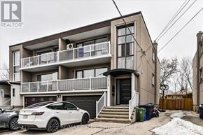 Toronto (Bathurst Manor) triplex for rent - A white car is parked in front of a two-story building.