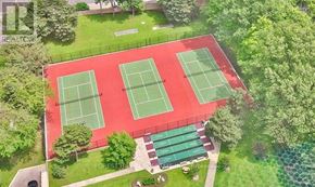 Mississauga (Applewood) condo for rent - Tennis courts surrounded by green trees and grass.
