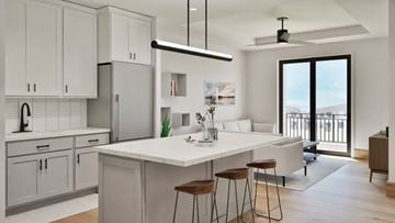 Madison apartment for rent - A modern kitchen with white cabinets and a large island.