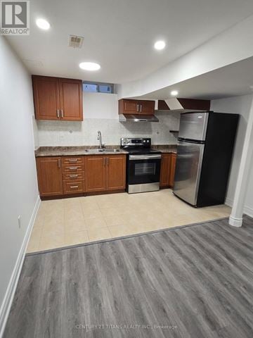 Markham (Greensborough) house for rent - A kitchen with wooden cabinets and stainless steel appliances.