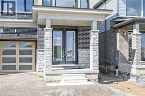 Hamilton house for rent - A house with a stone facade and a large glass door.