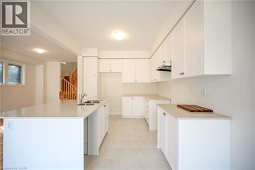 Hamilton house for rent - A white kitchen with a sink and cabinets.
