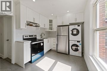 Hamilton apartment for rent - A modern kitchen with white cabinets and stainless steel appliances.