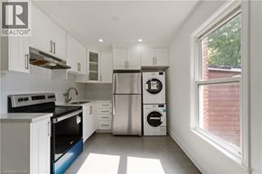 Hamilton apartment for rent - A kitchen with white cabinets and a stainless steel refrigerator.
