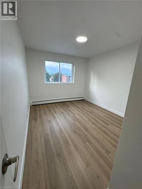 Waterloo apartment for rent - A room with a window and wooden flooring.