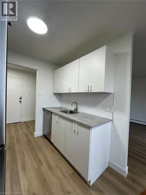 Waterloo apartment for rent - A kitchen with white cabinets and a sink.