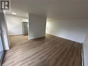 Waterloo apartment for rent - A room with wooden flooring and white walls.