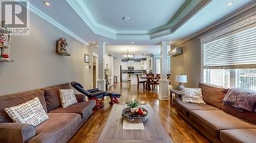 Logy Bay house for rent - A living room with brown couches and a wooden floor.