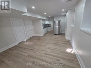 Milton (Cb Cobban) house for rent - A spacious kitchen with white cabinets and a refrigerator in the middle of the room.