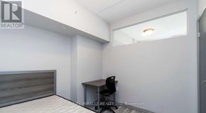 Waterloo condo for rent - A room with a desk and a chair in it.