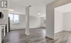 Toronto (Leaside) house for rent - A realtor photo of a large empty room with wood floors and white walls.