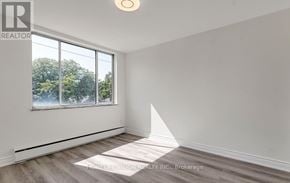 Toronto (Leaside) house for rent - A room with a large window and a white wall.