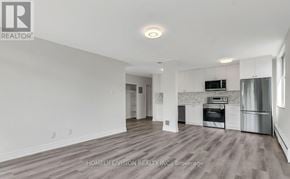 Toronto (Leaside) house for rent - A spacious kitchen with white cabinets and stainless steel appliances.