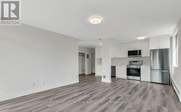 Toronto (Leaside) house for rent - A spacious kitchen with white cabinets and stainless steel appliances.