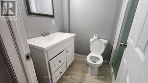 Niagara Falls (Brown) house for rent - A white toilet sits next to a sink in a bathroom.