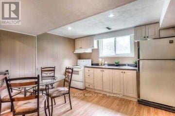 Markham (Markham Village) house for rent - A kitchen with white cabinets and a black fridge.