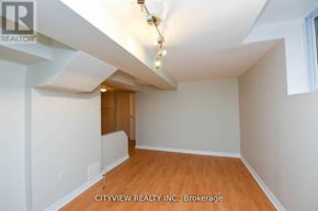 Mississauga (Meadowvale) house for rent - A room with a wooden floor and white walls, with a door in the middle of the room.