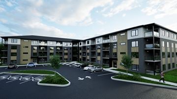Dieppe apartment for rent - A modern apartment complex with a parking lot in front.