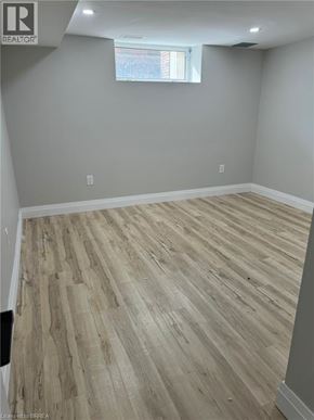 Brantford house for rent - A room with wooden flooring and a window.