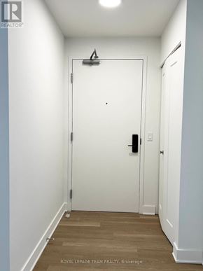 Ottawa multi-family for rent - A white door with a black handle and a black lock.