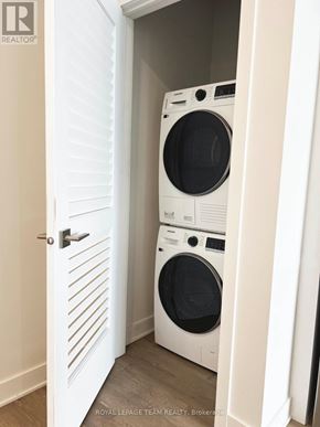Ottawa multi-family for rent - A white door with a washing machine behind it.
