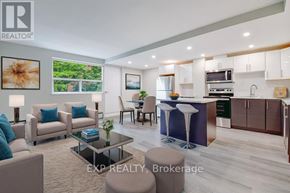 Mississauga (Cooksville) multi-family for rent - A modern living room with a kitchen area in the background.