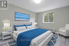 Mississauga (Cooksville) multi-family for rent - A bedroom with a large bed and a painting on the wall.