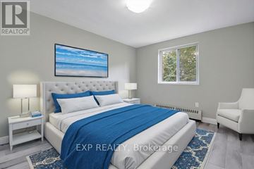 Mississauga (Cooksville) multi-family for rent - A bedroom with a large bed and a painting on the wall.