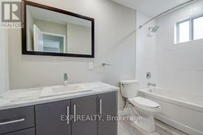 Mississauga (Cooksville) multi-family for rent - A bathroom with a sink, toilet, and bathtub.