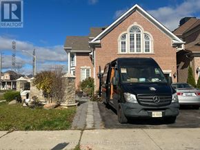 Ajax (Northwest Ajax) multi-family for rent - A black RE/MAX Community REALTY INC. van is parked in front of a brick house.