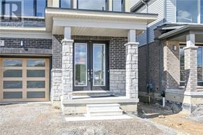 Hamilton house for rent - A modern house with a stone and wood exterior and a glass door.